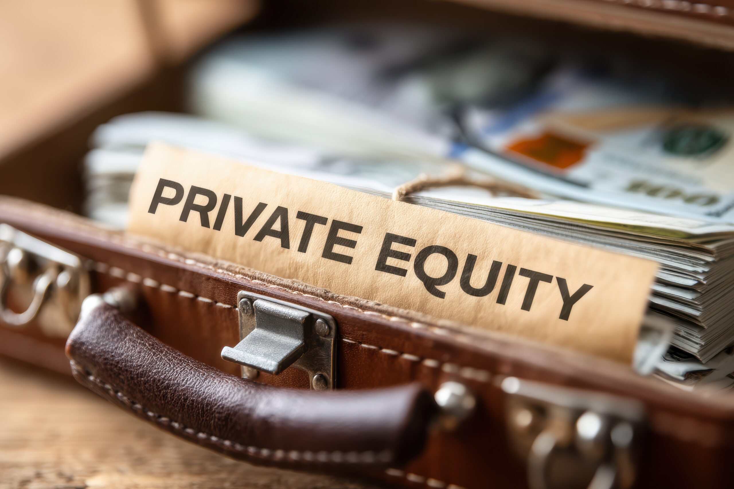 A briefcase filled with cash and a label reading "Private Equity" symbolizing investment and financial growth opportunities.