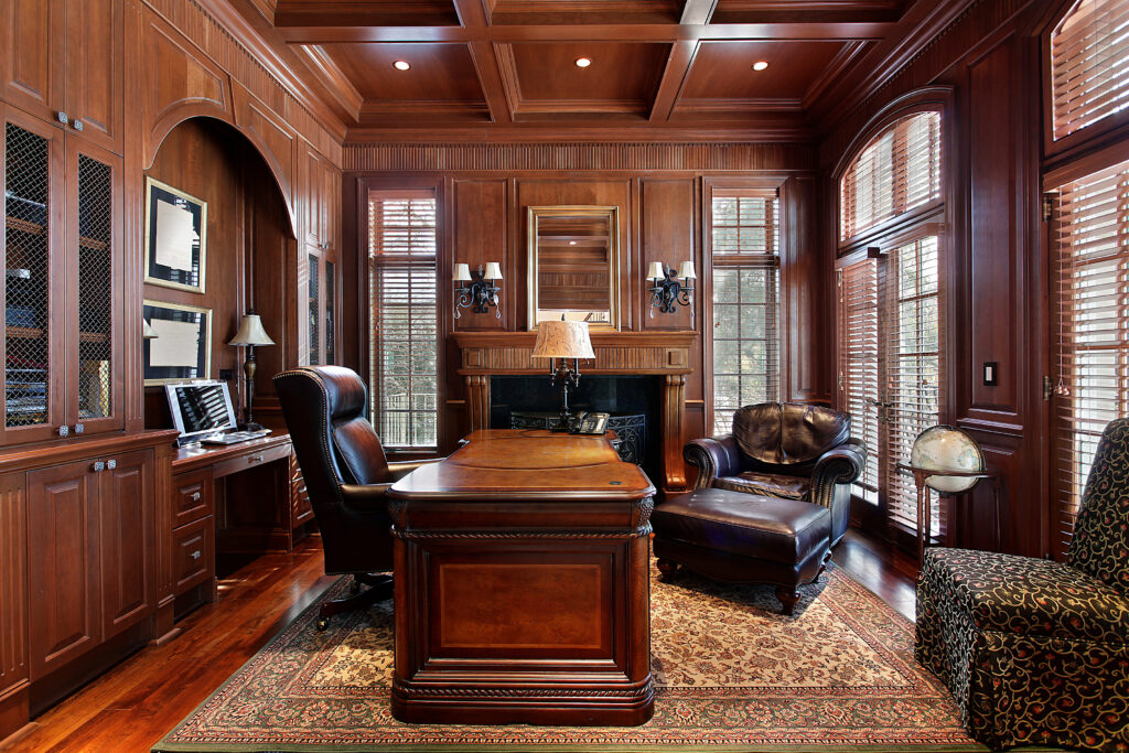 Library in luxury home with large desk