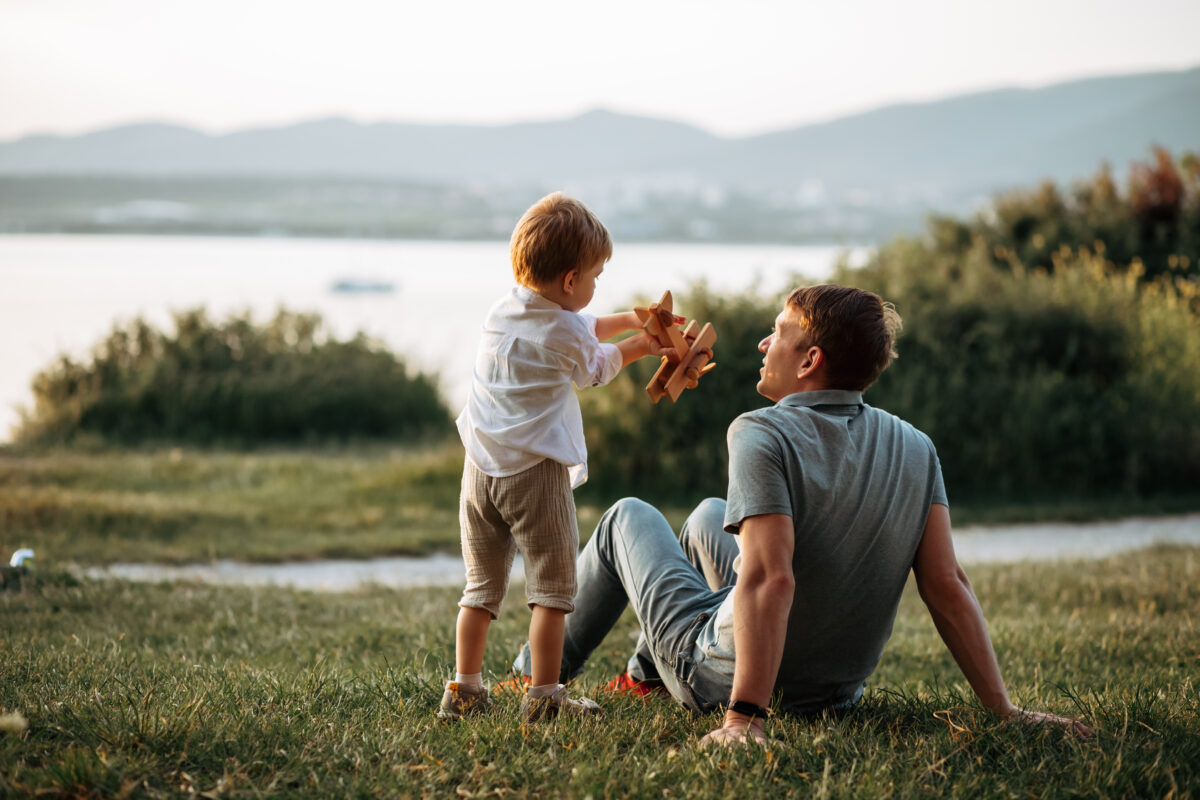 dad and son play on the seashore, vacation with children. Summer adventure, fun trip with kids. Fatherhood, Father's Day. Happy family travel and vacation concept